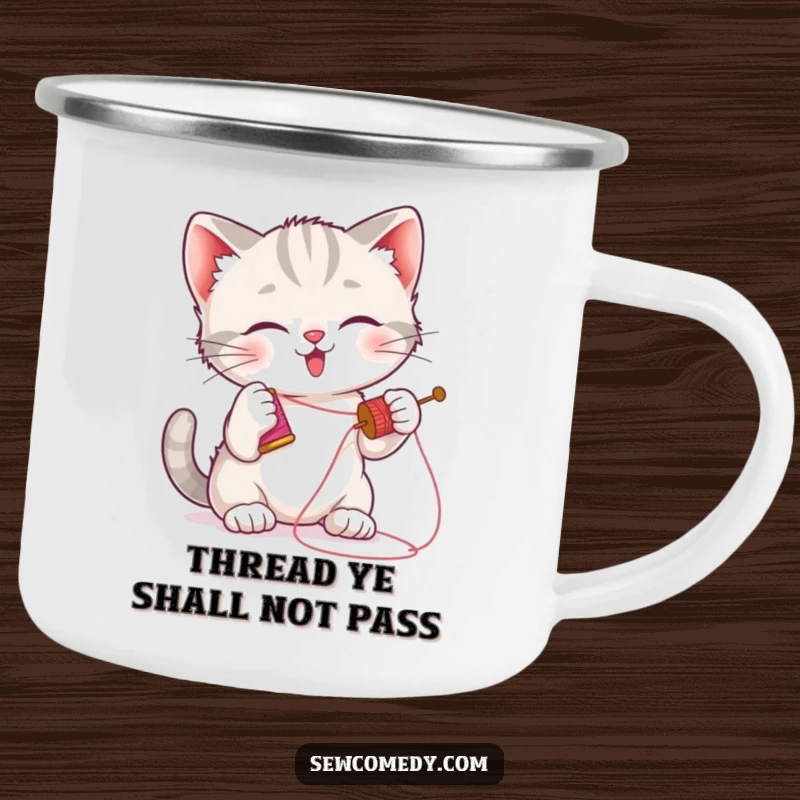 Funny kitten camping mug featuring a playful cat batting a needle and thread, durable outdoor mug.