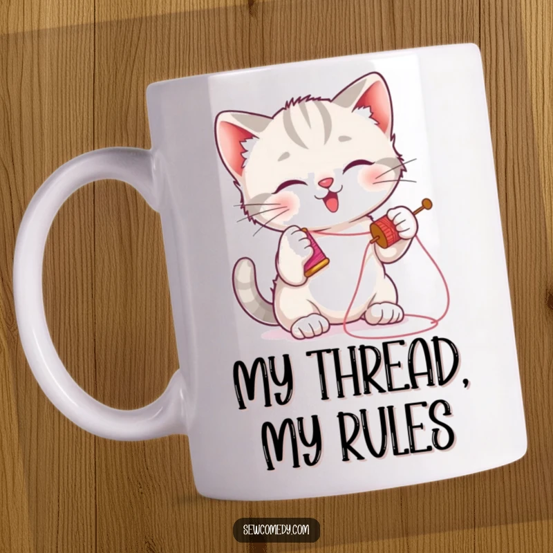 Funny kitten mug showing a playful cat batting at a needle with thread, perfect for crafters and cat lovers.